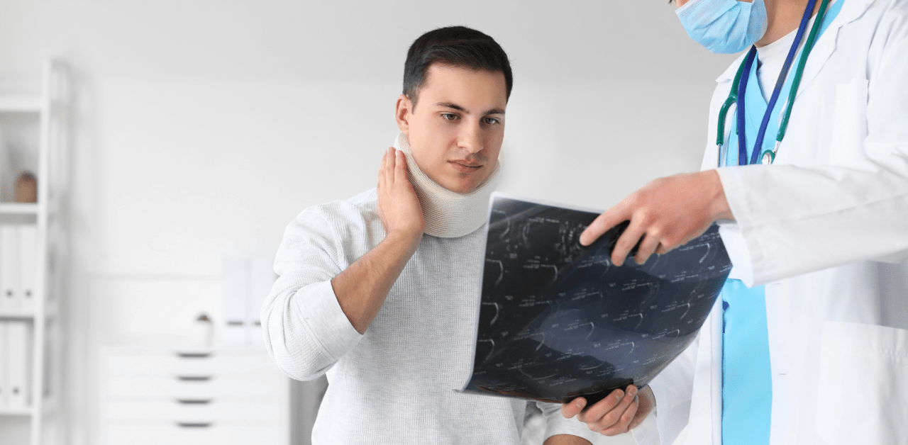 Man wearing a neck brace holding his neck, reviewing X-rays with a doctor in a clinical setting